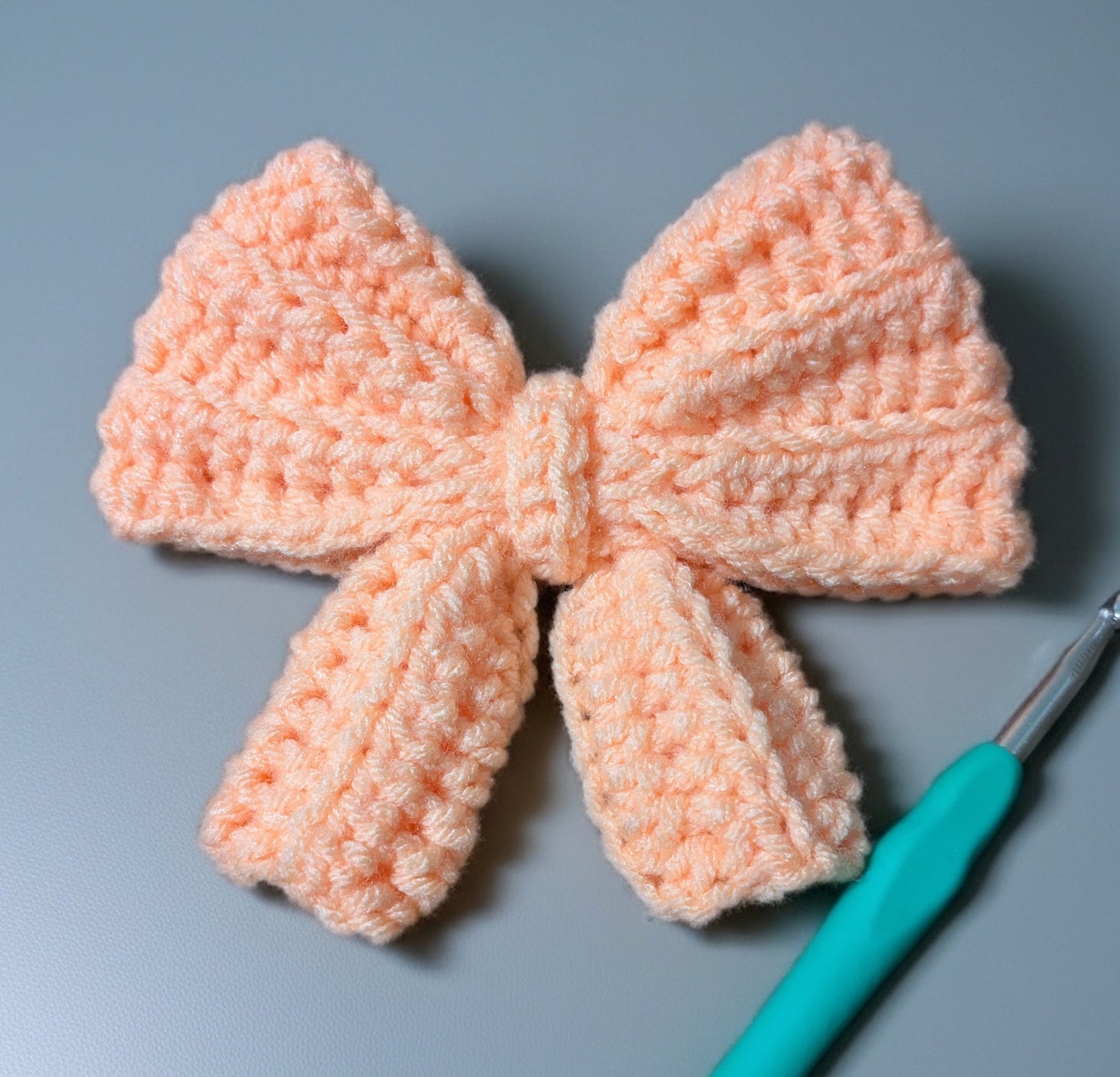 Handmade Crochet Bow Hair Tie – Soft Peach Bow Scrunchie – Cute Elastic Hair Accessory for Girls & Women